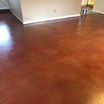 Finished glossy reddish-brown decorative stained concrete floor